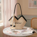 Beige Straw Tote Bag With Black Handles And Ribbon Charm