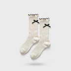 Cream Ribbed Knee High Socks With Black Bows