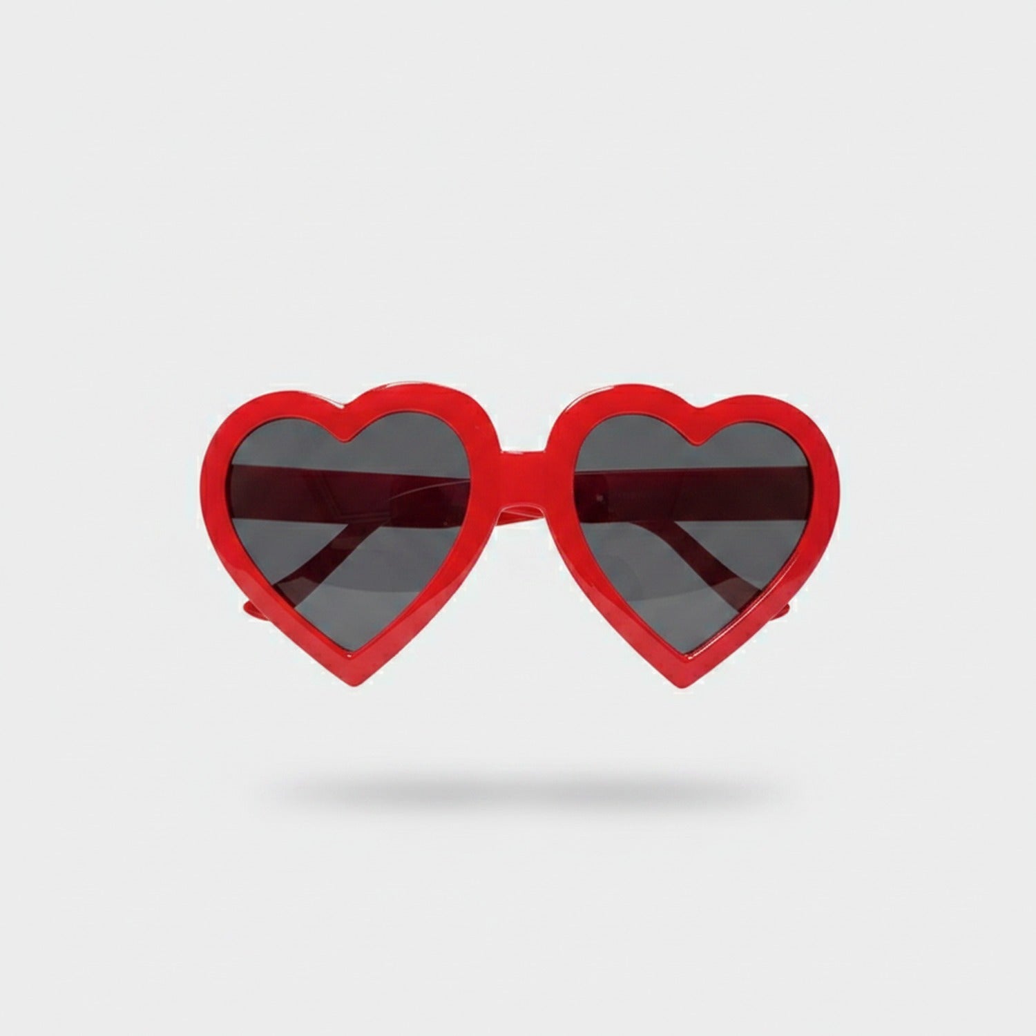 Red Heart-Shaped Sunglasses With Dark Lenses