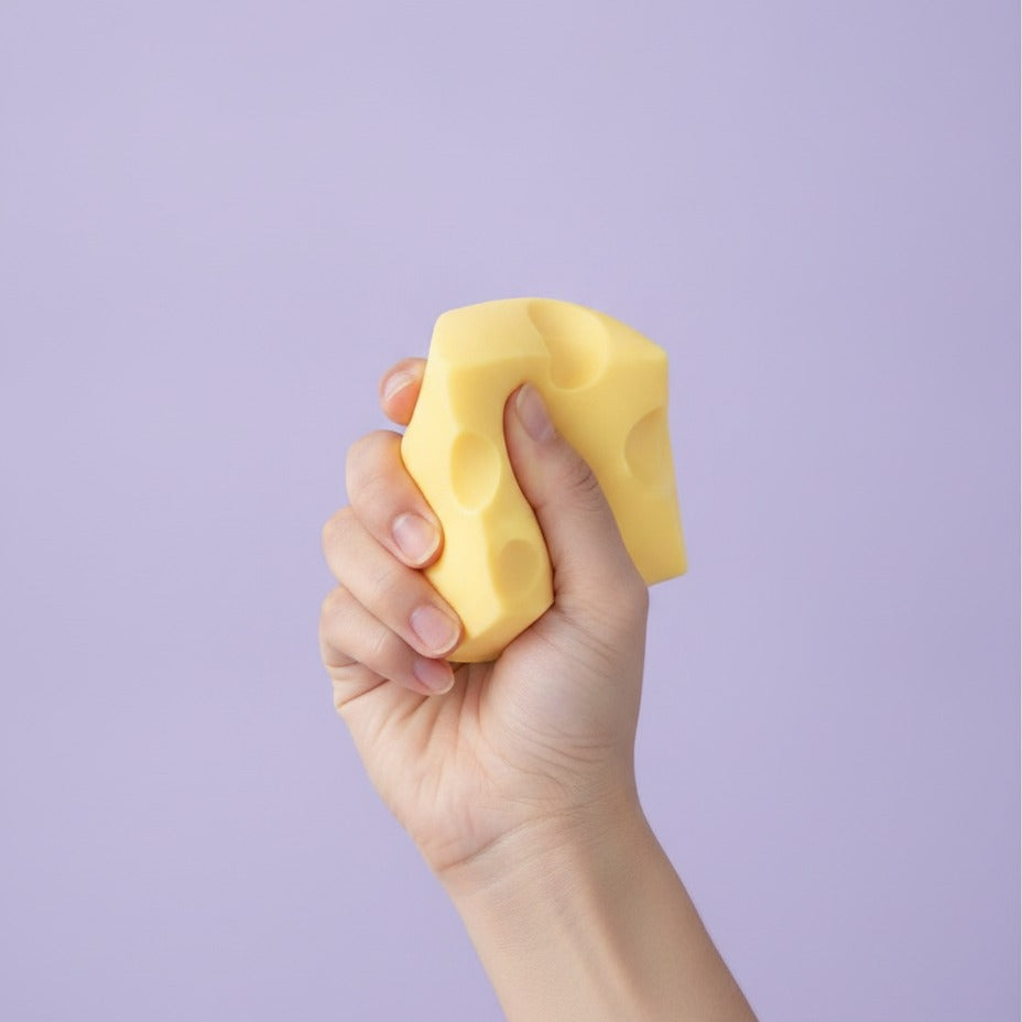 Floating Yellow Swiss Cheese Cube Decor - squeeze in hand