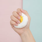Sunny Side Up Squishy - Yellow - squeeze in hand