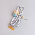 Rope Phone Charm With Doll And Tassel – tech (view 1)