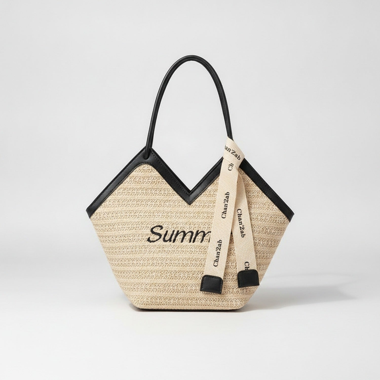 Beige Straw Tote Bag With Black Handles And Ribbon Charm – bags & wallets (view 1)