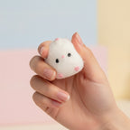 White Fuzzy Ghost Squishy With Pink Cheeks - squeeze in hand
