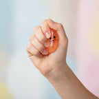 Grinning Ghost Squishy - Orange - squeeze in hand