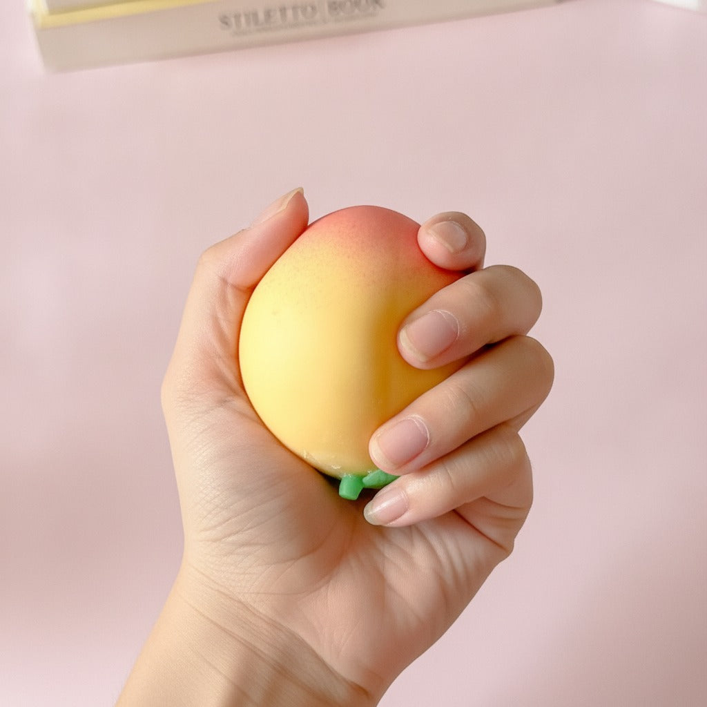 Peachy Keen Squishy Toy - Pink - squeeze in hand