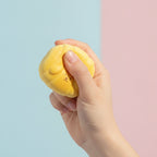 Squishy Melon Ball - Yellow - squeeze in hand
