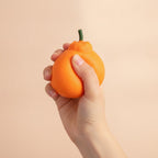 Squishy Pear Fruit Toy - Orange - squeeze in hand
